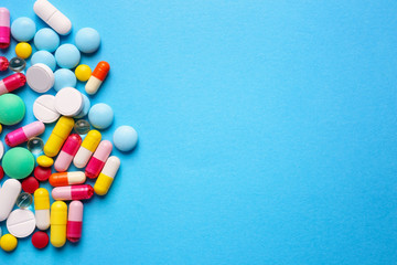 Different pills on color background