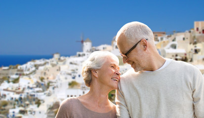 happy senior couple over santorini island - obrazy, fototapety, plakaty