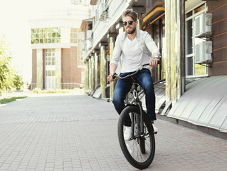 Obraz na płótnie Canvas Young man riding bicycle outdoors
