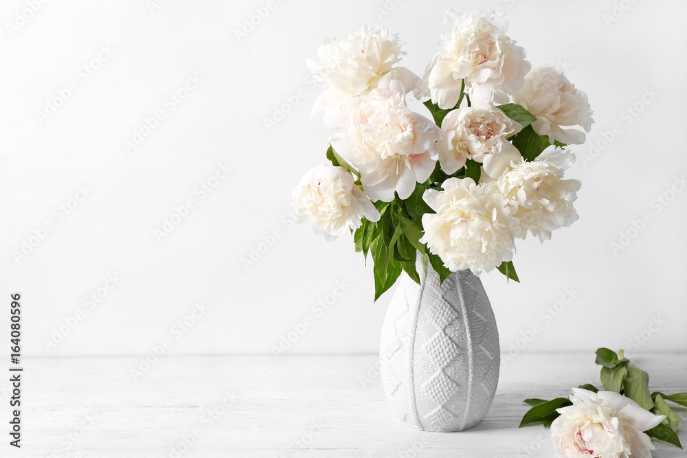 Wall mural Vase with beautiful peonies on white background