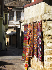 Fototapeta na wymiar historic district of Antalya and little alley with Rugs and carpets
