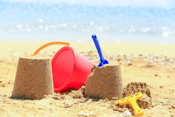 Composition with colorful toys on sea shore. Vacation concept