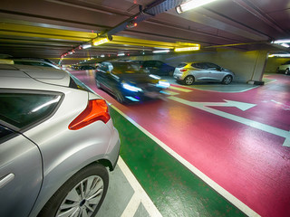 underground parking garage with a moving car