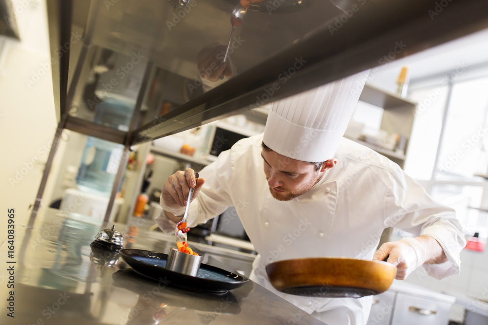 Poster happy male chef cooking food at restaurant kitchen