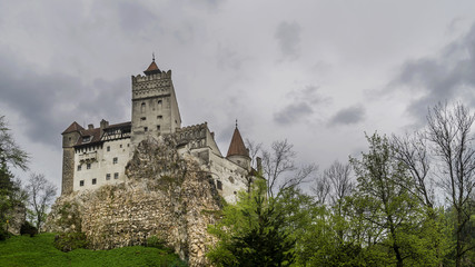 Fototapeta na wymiar View of the famous Bran castle in Brasov district, Transylvania, Romania, against a very gloomy sky