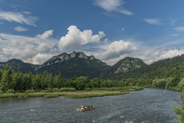 Boats on river Dunajec after rain with blue sky © luzkovyvagon.cz