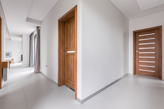 White apartment with wooden doors