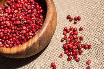 Pink pepper pile on wooden desk