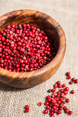Pink pepper pile on wooden desk