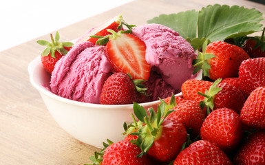 Strawberry ice cream on brown wood background