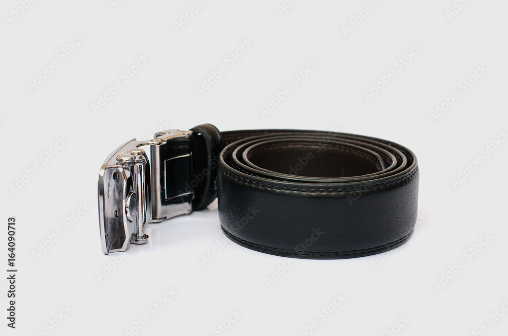 Wall mural black men's belt roll up isolated on white.