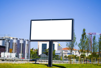 Blank billboard at skyscrapers backgound, mock up