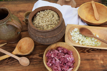 medieval cooking porridge in a metal pot on the fire