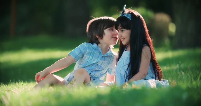 two small children,Caucasian boy and Asian girl having fun in the Park ,slow motion