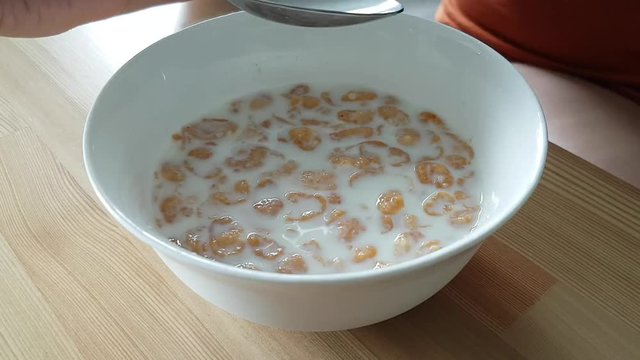 Eating corn flakes in milk for breakfast high speed time lapse