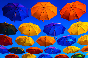 Obraz premium Colorful umbrellas against the blue sky
