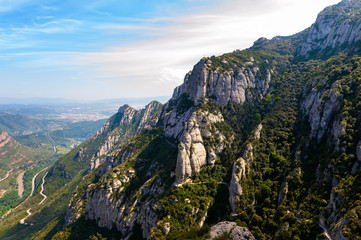 Fototapeta na wymiar Montserat rocks with near Santa Maria de Montserrat abbey in Spain