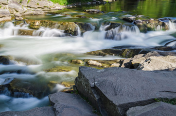 background landscape with waterfall in Yaremche vilage in Ukraine