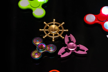 Hand spinners or fidgeting spinners. Many types and shapes of spinners put on the black background. 