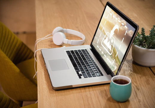 Laptop with Headphones on Table Mockup 1