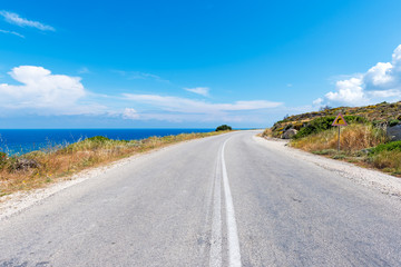 Beautiful coastal road along crystal blue sea water on Milos island. Cyclades, Greece