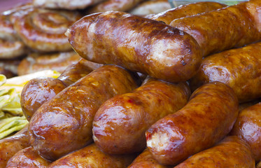Fototapeta premium Traditional food. Smoked sausages meat hanging in domestic smokehouse