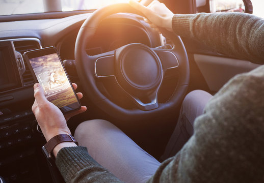 User with Smartphone in Car Mockup 1