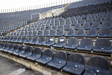 Naklejka premium Empty tribune with black seat on soccer sdadion