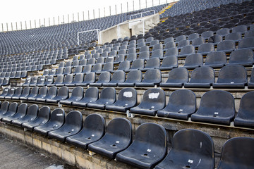 Empty tribune with black seat on soccer sdadion