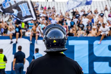 Fotobehang policeman with helmet guarding a sport event © fotosr52