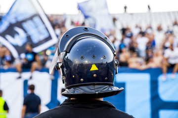 policeman with helmet guarding a sport event