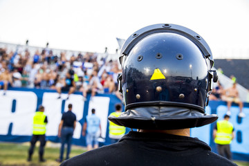 policeman with helmet guarding a sport event