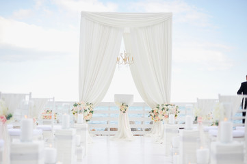 luxury wedding decorations with gentle rose and white tones, white wedding arch