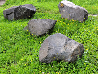 Boulders of shungite on lawn

