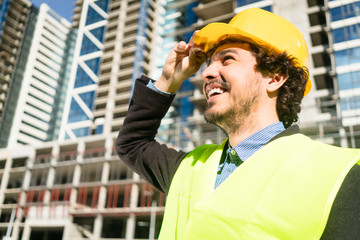 Civil engineer checks progress of construction works at building site