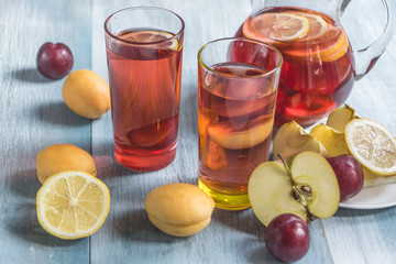 Homemade iced sweet tea with ripe apricots, plums and apples.