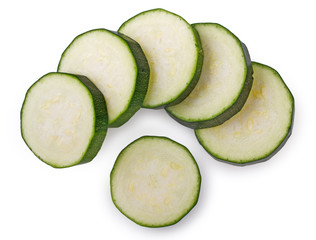 Slices of zucchini isolated on white background, top view, close up.