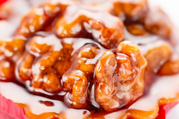 Walnut cake with caramel and honey. Close up on white background