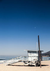 Moon over lifeguard booth at malibu beach