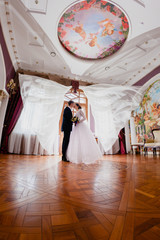 Obraz na płótnie Canvas Wedding couple and curtains flying in the air