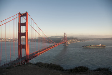 Golden Gate Bridge evening with container ship