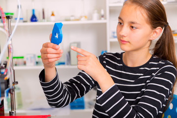 Schoolgirl with 3d printe. education, technology.