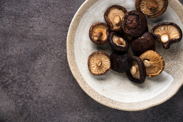 Dried shiitake mushroom on table background