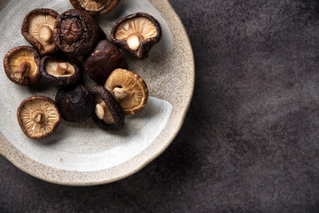 Dried shiitake mushroom on table background