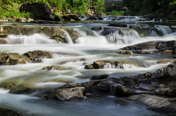 Fototapeta na wymiar background landscape with waterfall in Yaremche vilage in Ukraine