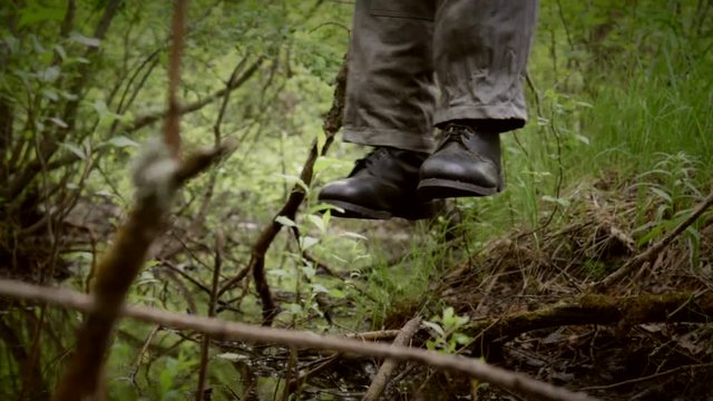 feet of hanged man over the rotten swamp, camera move from left to right