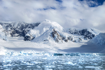 Fototapeta na wymiar Glacier carved snow capped mountains in Antarctica.