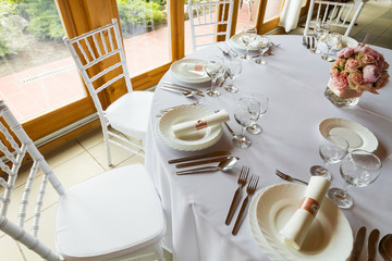 table setting with spoon, knife, plates and glass