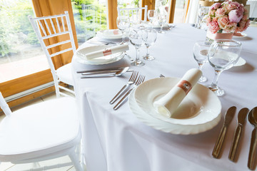 table setting with spoon, knife, plates and glass