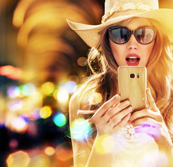 Beautiful, elegant woman using a smartphone